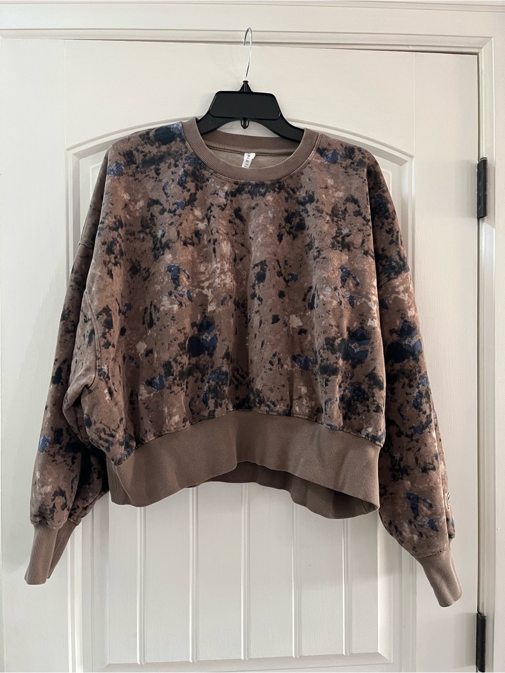 Fabletics sweatshirt with a brown, blue, gray camo pattern.